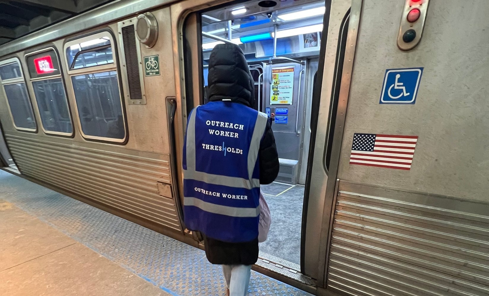 Thresholds staff member entering a train.